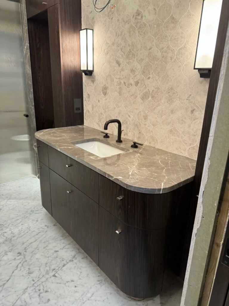 Bathroom vanity with a curved countertop and basin