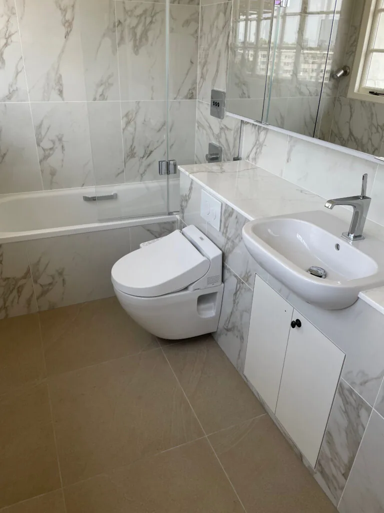 Bath and sanitaryware in a tiled bathroom
