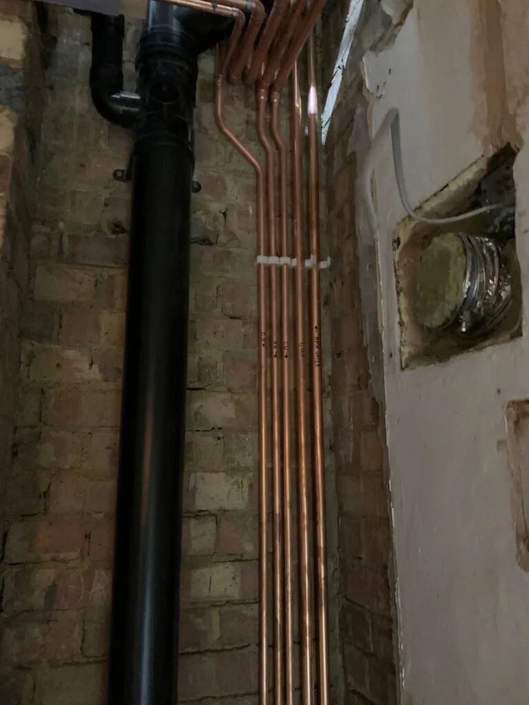 Vertical copper pipework in an open wall