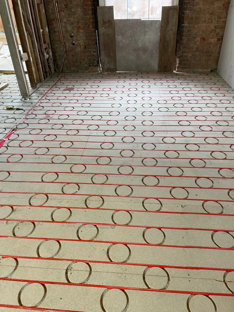 Underfloor heating pipe loops on an unfinished floor