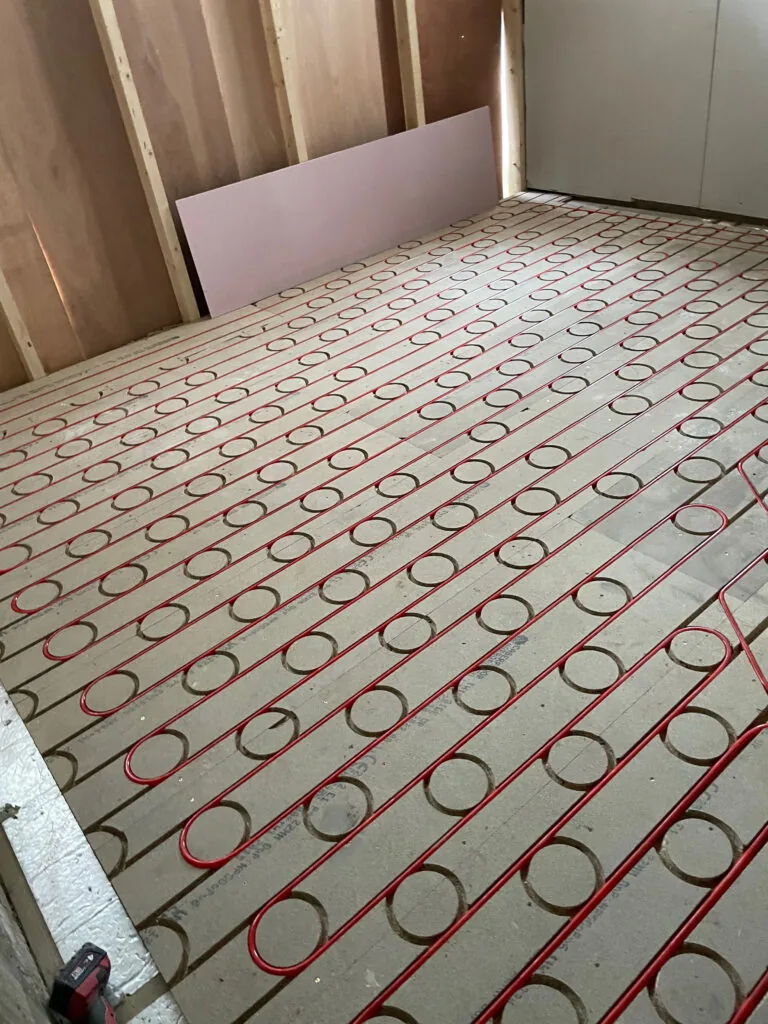Underfloor heating loops across an unfinished floor