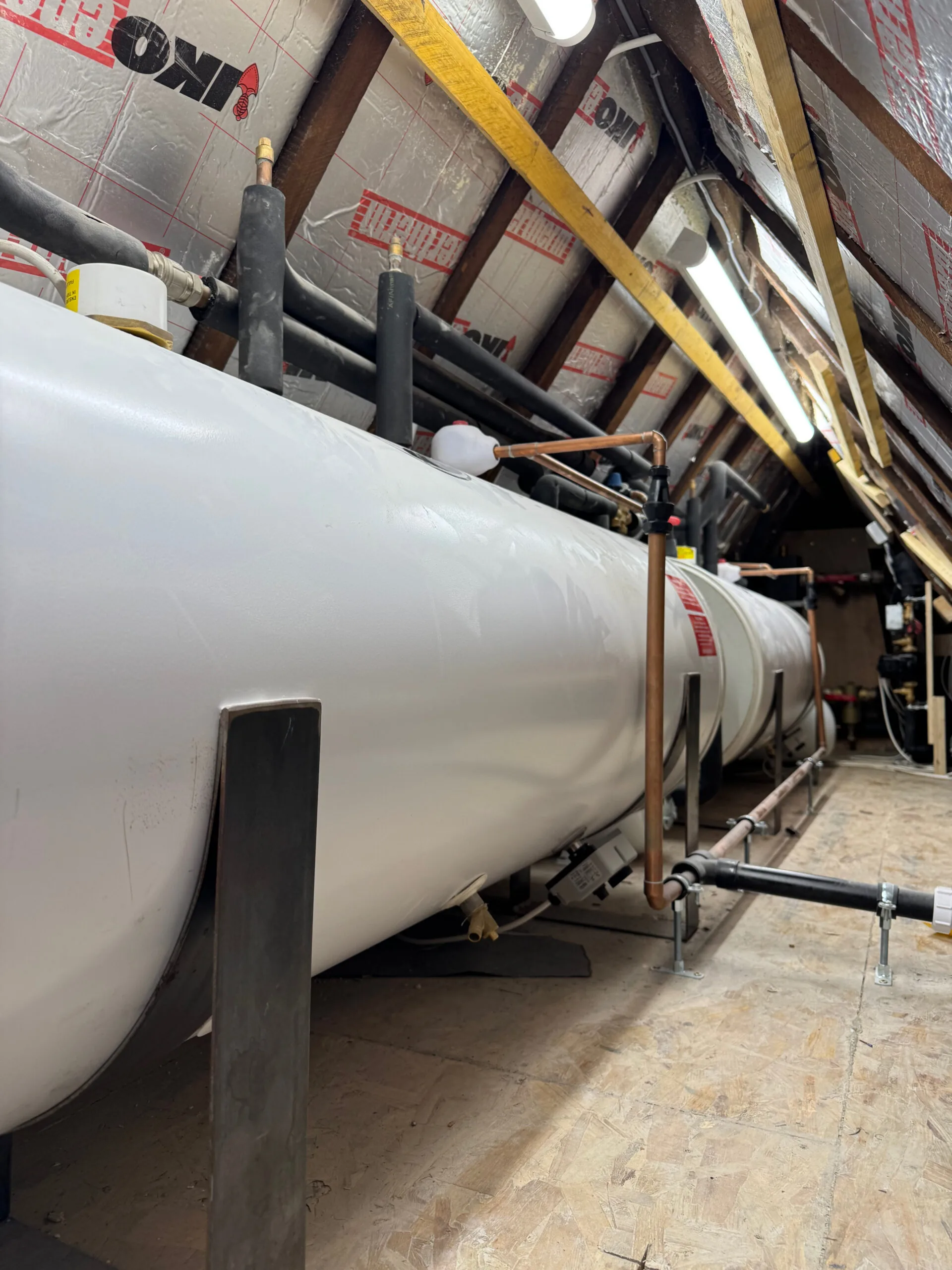 Hot water cylinder and associated pipework during installation