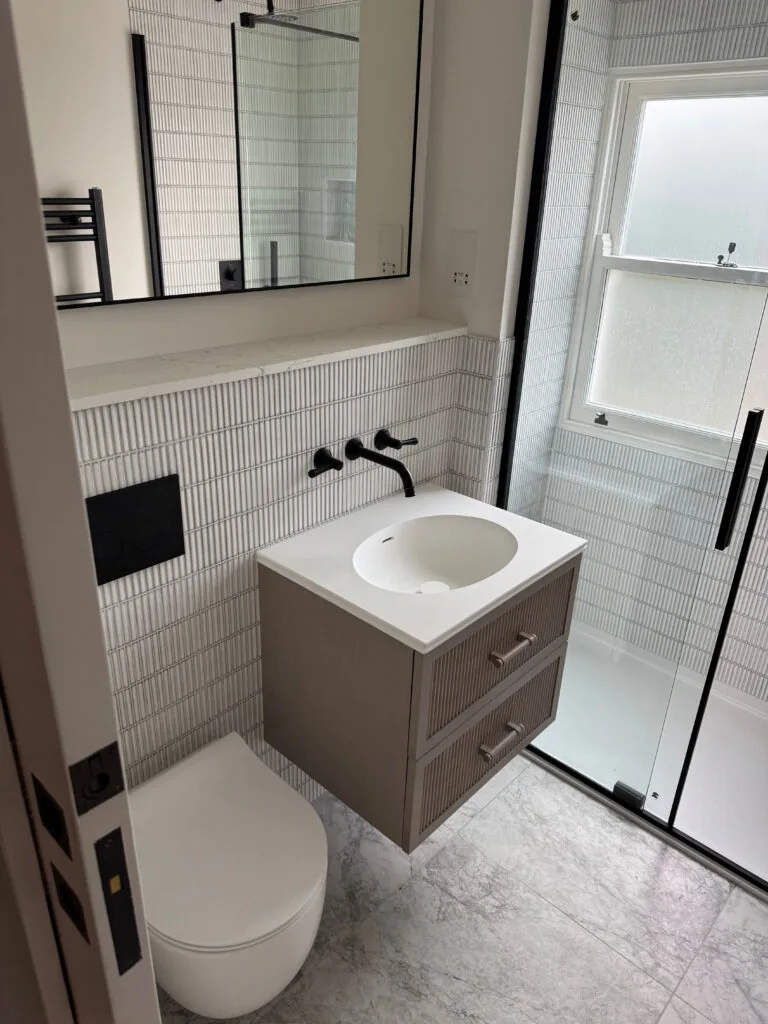 Square countertop basin on a wall-mounted vanity