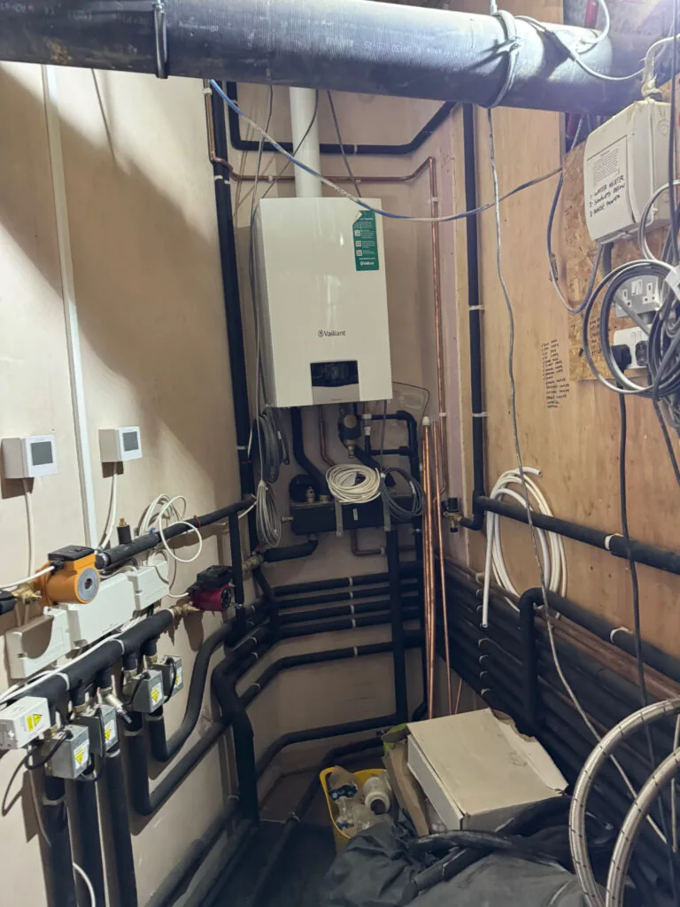 Heating equipment and insulated pipework in a plant room