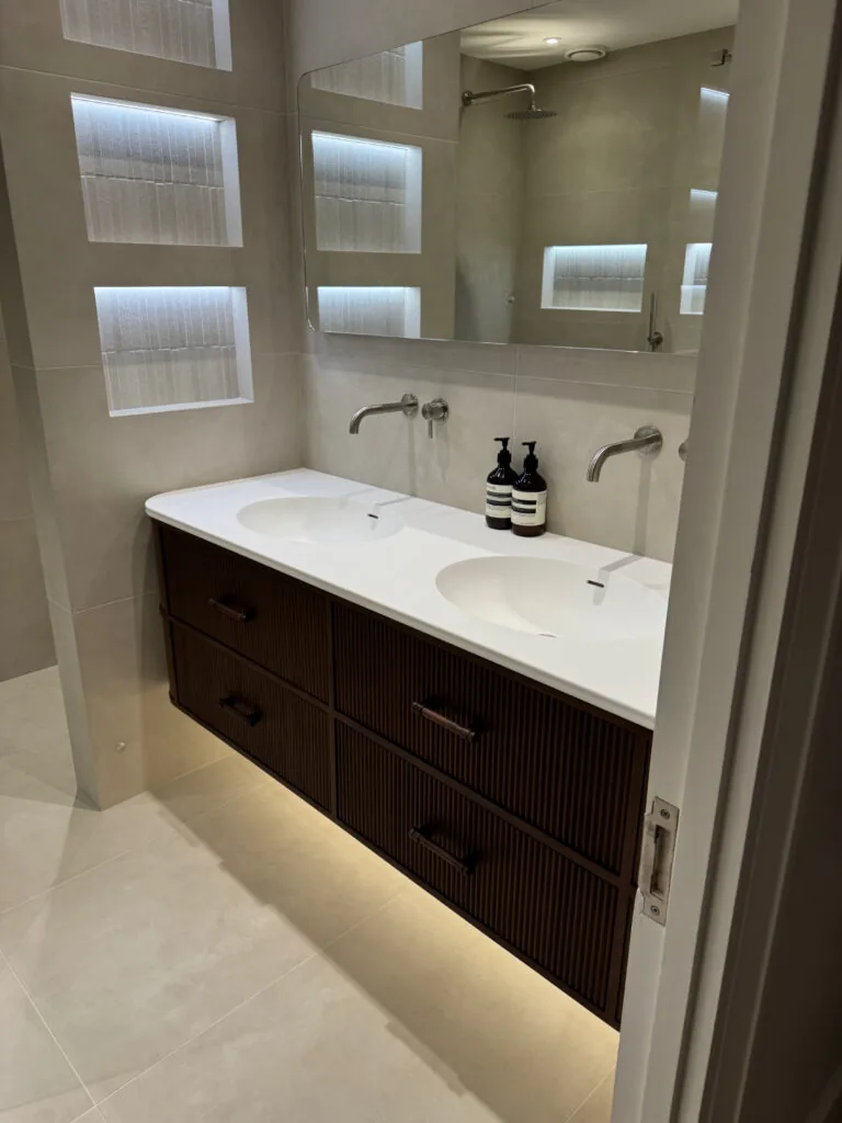 Double-basin vanity with wall-mounted taps and mirrors