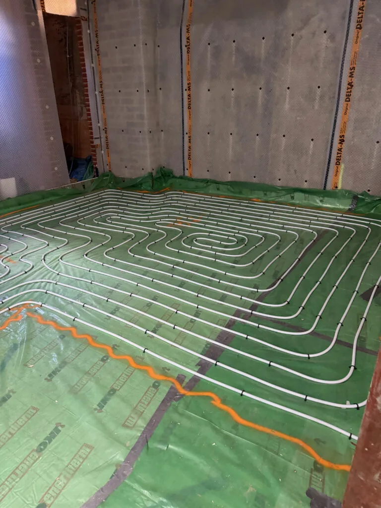 Underfloor heating pipes in an unfinished room