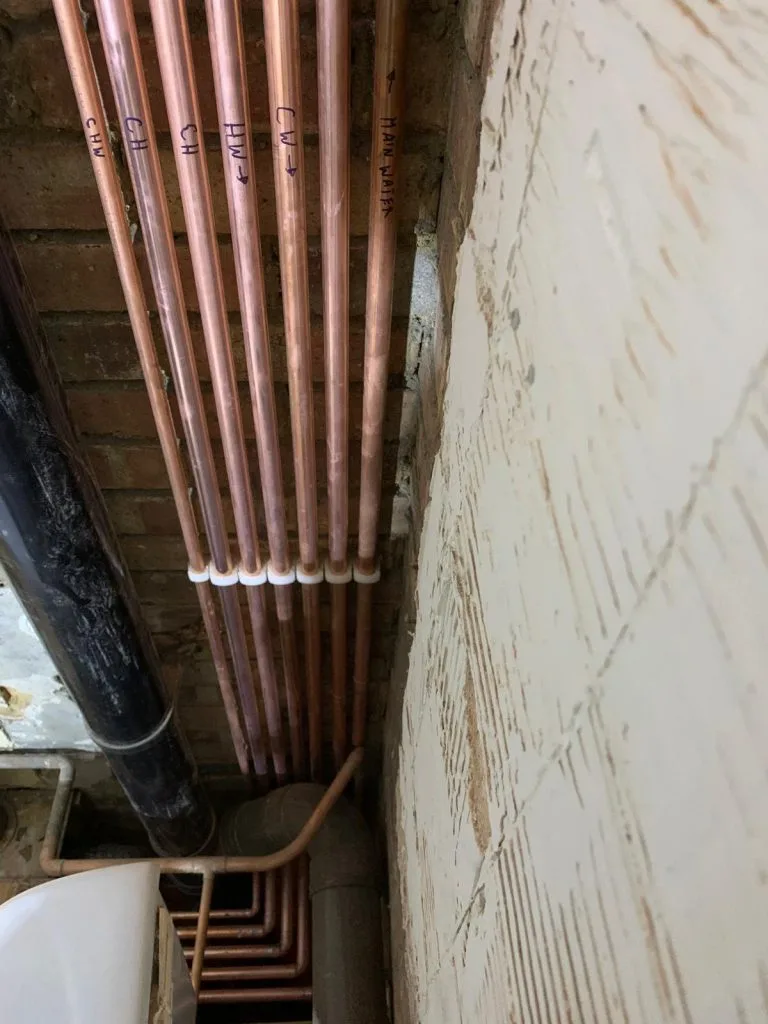 Copper pipework labelled for hot, cold and mains water during installation